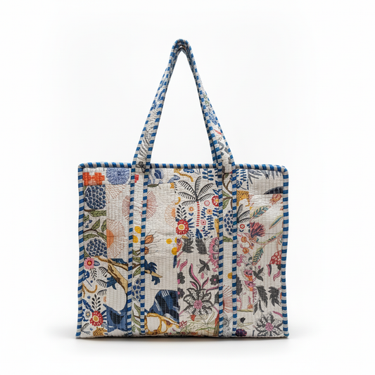Front view of the Draped In Heritage Colorful Jungle Tote, showcasing the quilted tropical print and two shoulder straps.