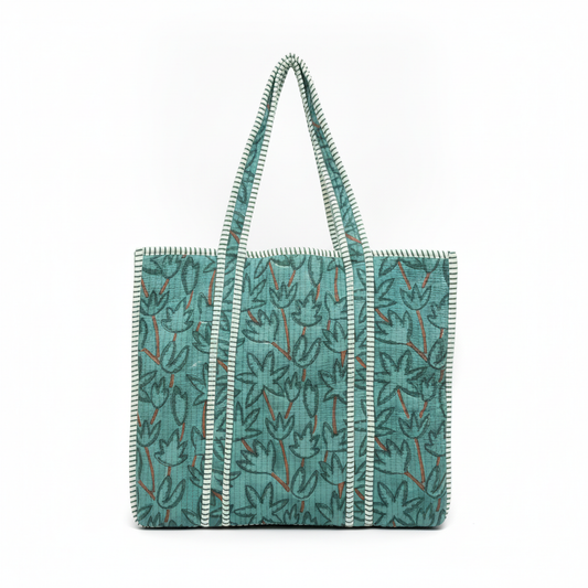 Front view of the Teal Botanical Quilted Tote Bag, showcasing the botanical print and exterior patch pocket.